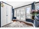 Stylish entryway with navy walls, white trim, hardwood floors, and sun-drenched windows at 1620 Dahlia St, Denver, CO 80220