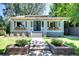 Charming single-story home with manicured lawn, inviting front porch, and beautiful flower boxes at 1620 Dahlia St, Denver, CO 80220
