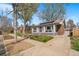 Charming brick home with sunroom, mature trees, and inviting curb appeal at 1620 Dahlia St, Denver, CO 80220