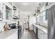 Bright white kitchen features stainless steel appliances, pendant lighting, and tiled flooring at 1620 Dahlia St, Denver, CO 80220
