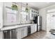 Bright kitchen featuring white cabinets, stainless appliances, and ample counter space at 1620 Dahlia St, Denver, CO 80220