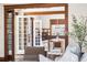 Open-concept living room and dining area with hardwood floors and natural lighting at 1620 Dahlia St, Denver, CO 80220
