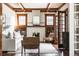Bright living room with white sofa, fireplace with mantel, hardwood floors and coffered ceiling at 1620 Dahlia St, Denver, CO 80220
