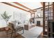 Inviting living room featuring hardwood floors, white walls, fireplace, and beamed ceiling at 1620 Dahlia St, Denver, CO 80220
