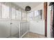 Charming sunroom with multiple windows, neutral tile, and white wood paneled walls at 1620 Dahlia St, Denver, CO 80220
