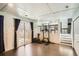 Finished basement with exercise equipment, wood floors, and access to the backyard at 13294 W 65Th Dr, Arvada, CO 80004