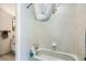 Bathroom features tiled bathtub and shower, modern hardware, and vanity beyond the door at 13294 W 65Th Dr, Arvada, CO 80004