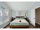 Bedroom boasts soothing paint, two large windows, and stylish decorations at 13294 W 65Th Dr, Arvada, CO 80004