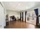 Spacious bonus room features wood floors, drop ceiling, and sliding glass doors to backyard at 13294 W 65Th Dr, Arvada, CO 80004