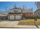 Charming two-story home with a two-car garage and inviting curb appeal on a sunny day at 13294 W 65Th Dr, Arvada, CO 80004
