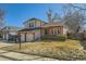 Charming two-story home features a well-manicured lawn and an attached two-car garage at 13294 W 65Th Dr, Arvada, CO 80004