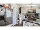 Open kitchen next to dining area with stainless steel refrigerator and granite countertop at 13294 W 65Th Dr, Arvada, CO 80004
