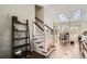 Staircase features white wood trim, dark wood steps and opens to a room with skylights at 13294 W 65Th Dr, Arvada, CO 80004
