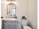 Charming half bathroom features elegant fixtures, stylish vanity, and a decorative mirror at 10610 Moore Ct, Westminster, CO 80021