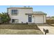 Charming two-story home featuring light siding, blue door, and attached garage for convenient parking at 10610 Moore Ct, Westminster, CO 80021