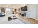 Inviting living room boasts a large sectional, modern entertainment center, and hardwood flooring at 10610 Moore Ct, Westminster, CO 80021