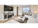 Beautifully designed living room with stylish furniture, a large window, and a decorative entertainment center at 10610 Moore Ct, Westminster, CO 80021