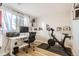 Bright office featuring a modern desk, Peloton bike, and natural light from the window at 10610 Moore Ct, Westminster, CO 80021