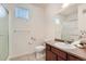 This bathroom offers a glass shower, granite sink top and countertop, toilet, mirror, and silver fixtures at 803 E 98Th Ave # 105, Thornton, CO 80229