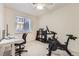 Cozy bedroom featuring a modern desk, storage, and exercise bike for a convenient workout space at 803 E 98Th Ave # 105, Thornton, CO 80229