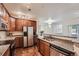 Well-lit kitchen with stainless steel appliances, granite counters, and an open layout to the living area at 803 E 98Th Ave # 105, Thornton, CO 80229