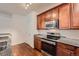 A functional kitchen features dark wood cabinetry, stainless steel appliances, and granite countertops at 803 E 98Th Ave # 105, Thornton, CO 80229