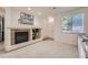 Open living area with a cozy fireplace, a large window, and neutral walls creating a welcoming ambiance at 803 E 98Th Ave # 105, Thornton, CO 80229