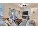 Bright living room showcasing a modern ceiling fan, sliding glass doors to a patio, and stylish decor at 803 E 98Th Ave # 105, Thornton, CO 80229