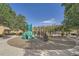 Colorful community playground with climbing structures, slides, and swings surrounded by mature trees at 803 E 98Th Ave # 105, Thornton, CO 80229