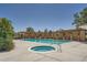Resort style community pool and hot tub, surrounded by pergolas and lounge chairs on a sunny day at 803 E 98Th Ave # 105, Thornton, CO 80229
