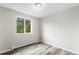 Bright bedroom with wood-look floors, neutral walls, and a window offering natural light at 795 S Alton Way # 11C, Denver, CO 80247
