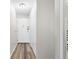Hallway with wood-look floors, neutral walls, and white trim leading to the front door at 795 S Alton Way # 11C, Denver, CO 80247