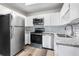 Updated kitchen with stainless steel appliances, white cabinets, granite countertops, and subway tile backsplash at 795 S Alton Way # 11C, Denver, CO 80247