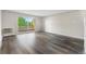 Spacious living room with sliding glass doors opening to a balcony and wood-look floors at 795 S Alton Way # 11C, Denver, CO 80247