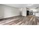 Open-concept living room featuring wood-look floors adjacent to a renovated kitchen at 795 S Alton Way # 11C, Denver, CO 80247