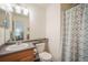 Bathroom featuring a vanity, toilet, and shower with a decorative curtain, creating a functional space at 114 Vale St, Palmer Lake, CO 80133