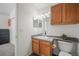 Bathroom with wood cabinets, gray countertop, and a modern sink at 114 Vale St, Palmer Lake, CO 80133