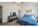 Bright bedroom features light walls, carpet, and a TV with storage below at 114 Vale St, Palmer Lake, CO 80133