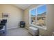 Bedroom featuring large view window, plush carpet, storage ottoman, and mountain views at 114 Vale St, Palmer Lake, CO 80133