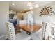 Bright dining area with a wooden table, stylish chairs, and a unique wine rack, perfect for entertaining guests at 114 Vale St, Palmer Lake, CO 80133