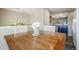 Elegant dining room featuring a wooden table, upholstered chairs, and a view into a kitchen with blue cabinets at 114 Vale St, Palmer Lake, CO 80133