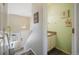 Entryway featuring a modern light fixture, staircase, and half bathroom for convenience and practicality at 114 Vale St, Palmer Lake, CO 80133