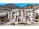 Inviting townhomes featuring red accents, private garages, and mountain views for a scenic and comfortable living experience at 114 Vale St, Palmer Lake, CO 80133