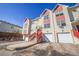 Charming townhome featuring a red-accented entrance, private garages and sunny exposure at 114 Vale St, Palmer Lake, CO 80133