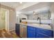 Stylish kitchen featuring sleek stainless steel appliances, contrasting navy cabinets, and a convenient layout for easy cooking at 114 Vale St, Palmer Lake, CO 80133