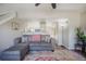 Spacious living room featuring a plush sofa and ceiling fan for relaxing comfort and seamless entertaining at 114 Vale St, Palmer Lake, CO 80133