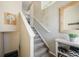 View of carpeted stairs with white railing and wall decorations at 114 Vale St, Palmer Lake, CO 80133