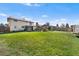 Large backyard with a well-manicured lawn, fence, and a shed, perfect for outdoor activities at 3191 S Holly Pl, Denver, CO 80222