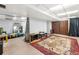 Spacious basement with unique rugs and curtains separating spaces at 3191 S Holly Pl, Denver, CO 80222