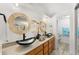 Stylish bathroom showcasing double sinks with vessel bowls and modern fixtures at 3191 S Holly Pl, Denver, CO 80222